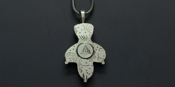 back view of cactus necklace showing plant/tropical motif stamped in silver.