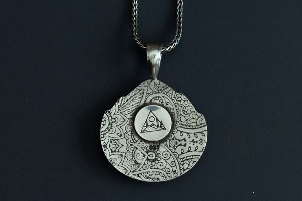 back view of a Handmade Starfox Variscite stone necklace in sterling silver with paisley design stamped onto back