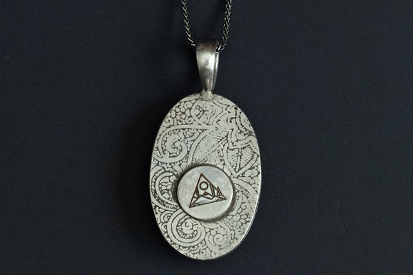 back view of Handmade White Buffalo stone necklace set in sterling silver with a paisley pattern stamped on the back