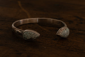 Two blue and gray teardrop stones on a sterling silver cuff