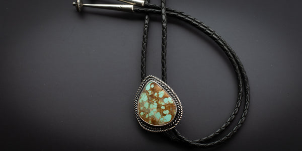 Handmade #8 turquoise bolo tie with twist wire detailing 