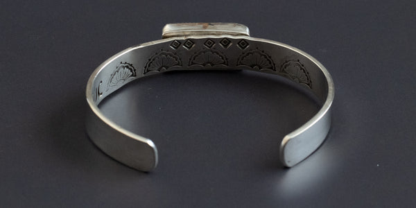 Inside view of a thick gauge sterling silver cuff, hand stamped  and handmade with a campitos turquoise stone