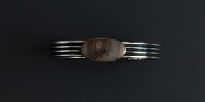 Imperial Jasper oval stone set in a plain bezel with a pattern wire cuff.  Handmade sterling silver cuff