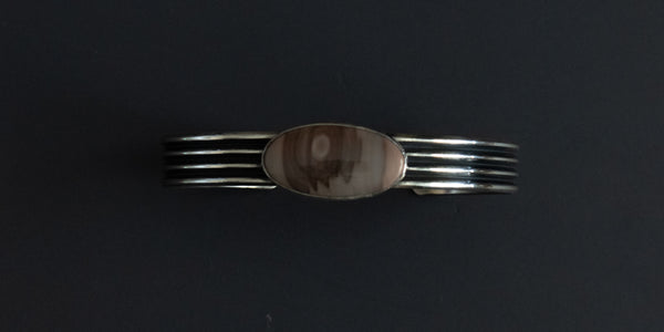 Imperial Jasper oval stone set in a plain bezel with a pattern wire cuff.  Handmade sterling silver cuff