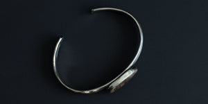 Side view of a handmade sterling silver cuff with an Imperial Jasper stone set in a plain bezel