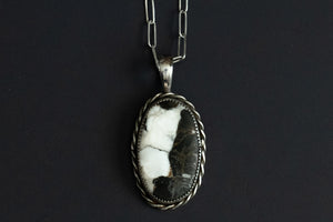 White buffalo stone pendant set in sterling silver and a twisted wire feature