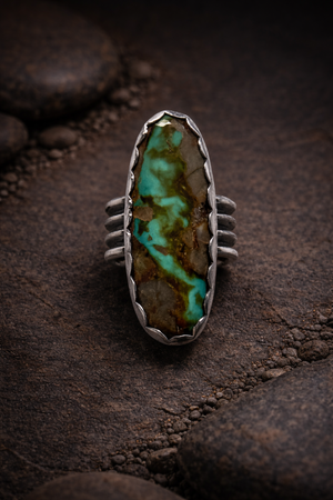 #8 Turquoise oval stone set in .925 sterling silver with a scalloped bezel and wide ring band