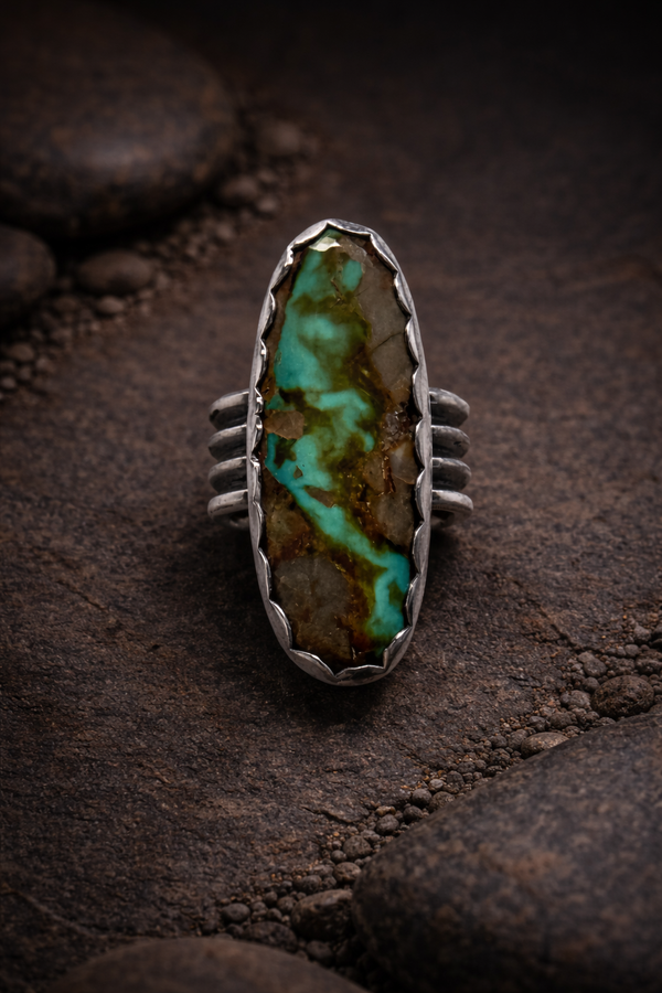 #8 Turquoise oval stone set in .925 sterling silver with a scalloped bezel and wide ring band