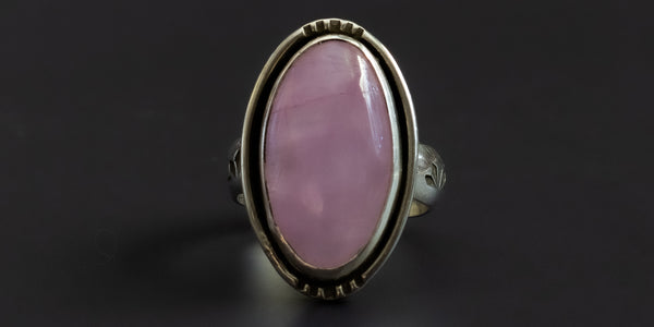 Handmade sterling silver ring with an oval shaped, pink, kunzite stone set in a plain bezel and a hand-stamped ring shank